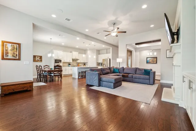 a living room with furniture and wooden floor