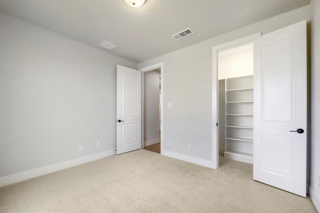 800 Blackberry Road Haslet, TX 76052 - Photo 11 of 28 Carpeted room with light neutral wall paint, white trim, and a ceiling light fixture