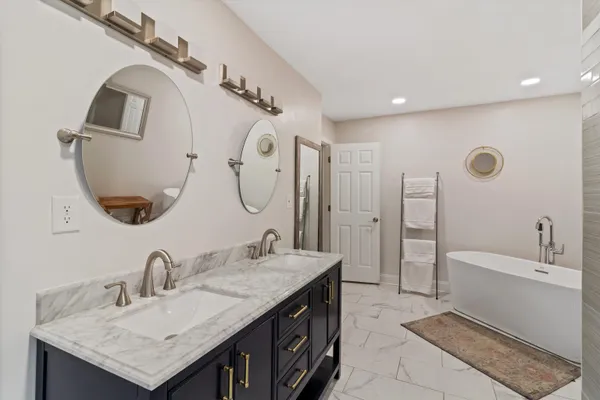 a bathroom with a double vanity sink and a mirror