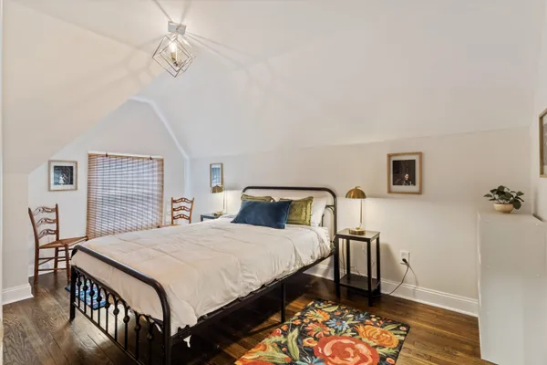 a bedroom with a bed and a table