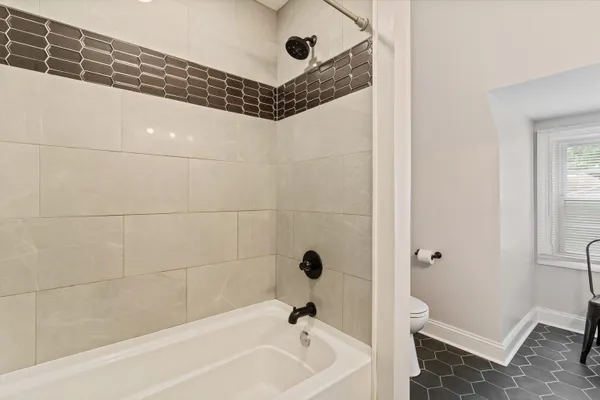 a bathroom with a tub shower and vanity