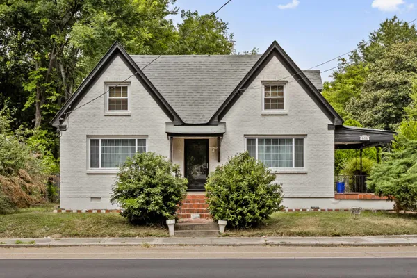 a view of a house with a yard and plants