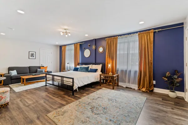 a spacious bedroom with a bed and a dresser