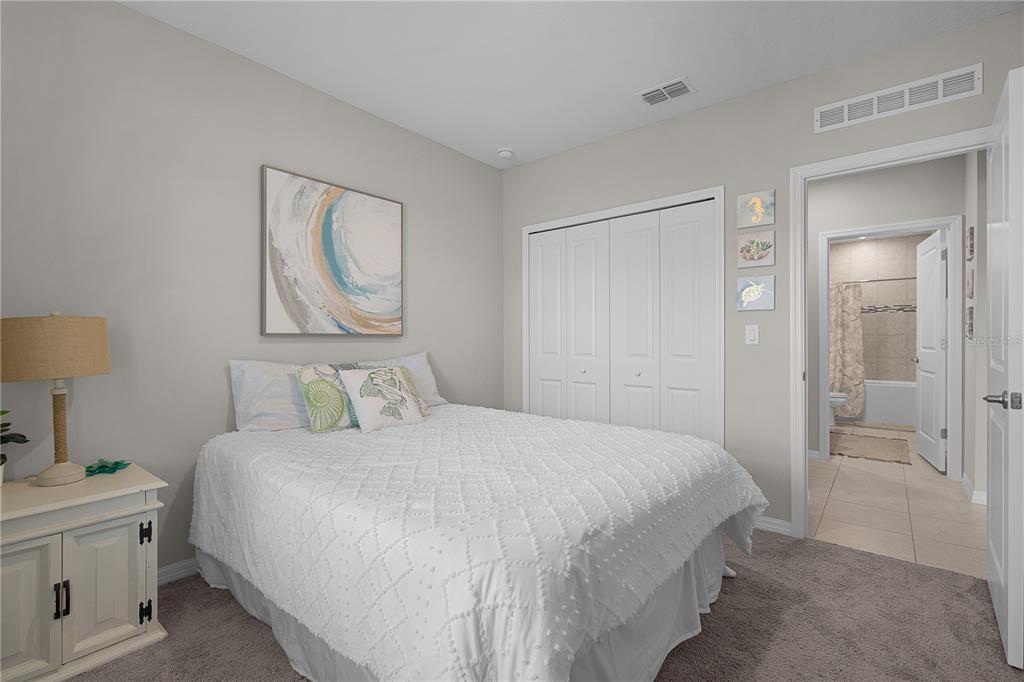 418 Fleming Street Sebastian, FL 32958 - Photo 21 of 38 a bedroom with a bed and a lamp