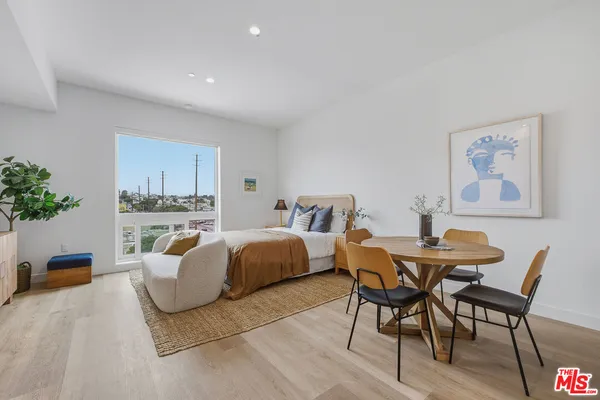 a spacious bedroom with a bed and a table