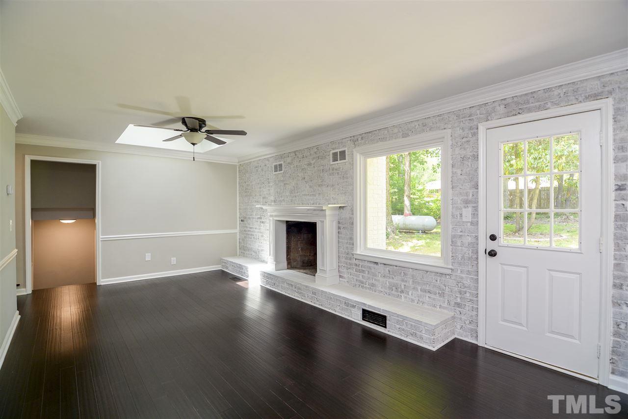131 Lin Tilley Road Durham, NC 27712 - Photo 11 of 25 a view of an empty room with wooden floor and a window