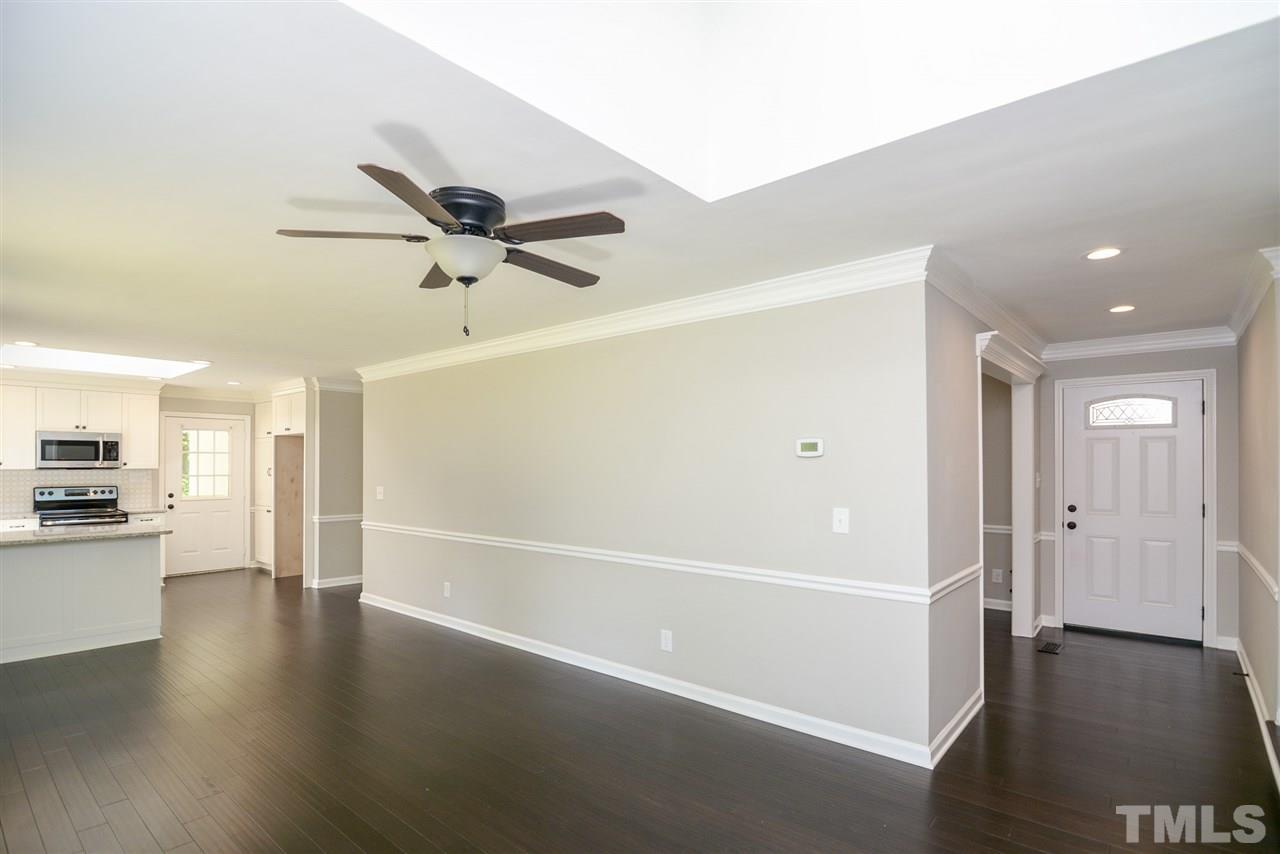 131 Lin Tilley Road Durham, NC 27712 - Photo 14 of 25 a view of a livingroom with a ceiling fan hardwood floor and a ceiling fan