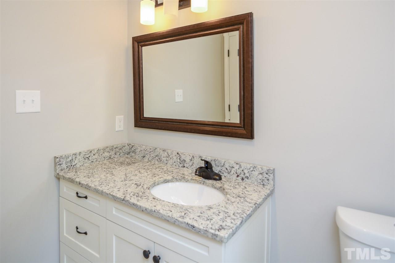 131 Lin Tilley Road Durham, NC 27712 - Photo 19 of 25 a bathroom with a granite countertop sink and a mirror