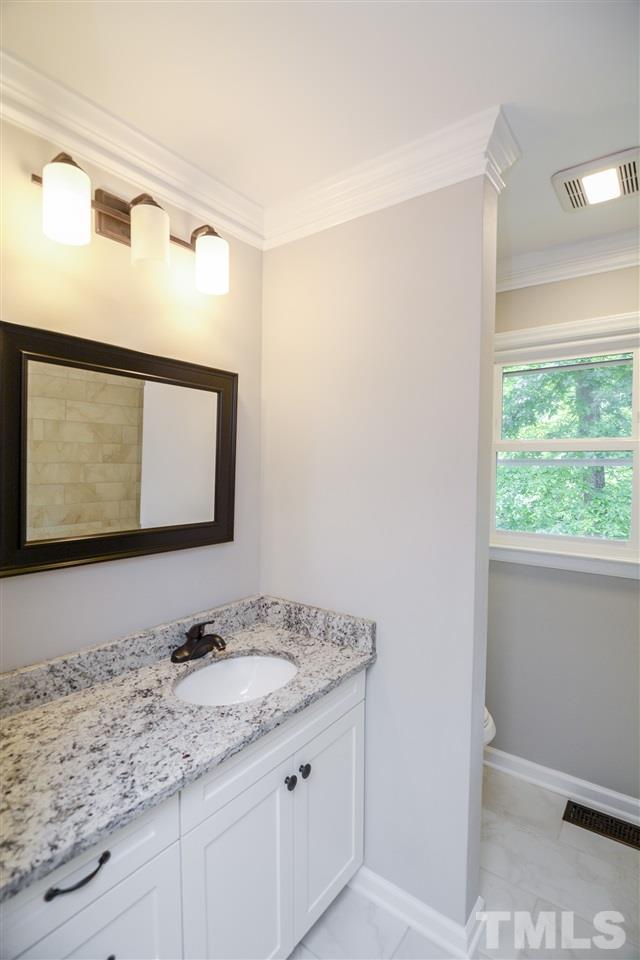 131 Lin Tilley Road Durham, NC 27712 - Photo 24 of 25 a bathroom with a granite countertop sink and a mirror