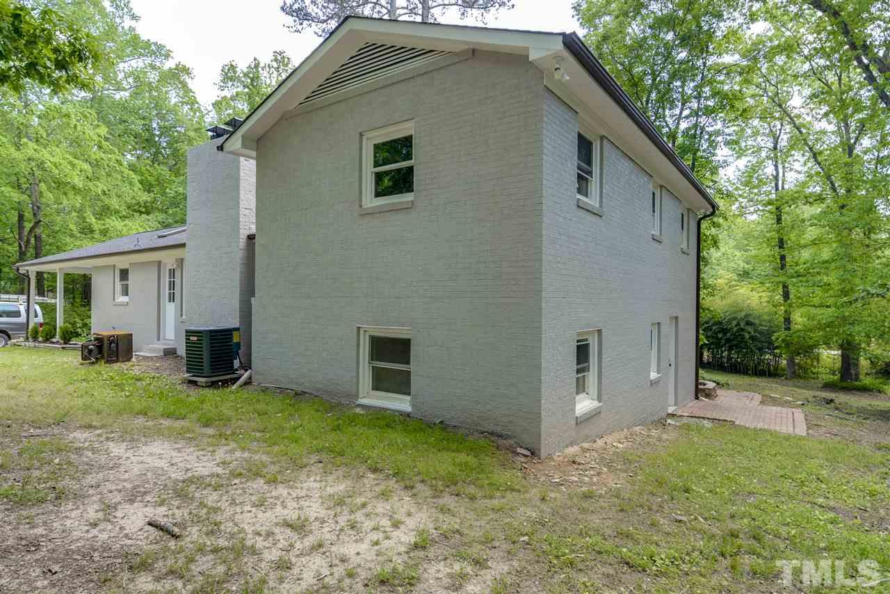 131 Lin Tilley Road Durham, NC 27712 - Photo 4 of 25 a house with trees in the background