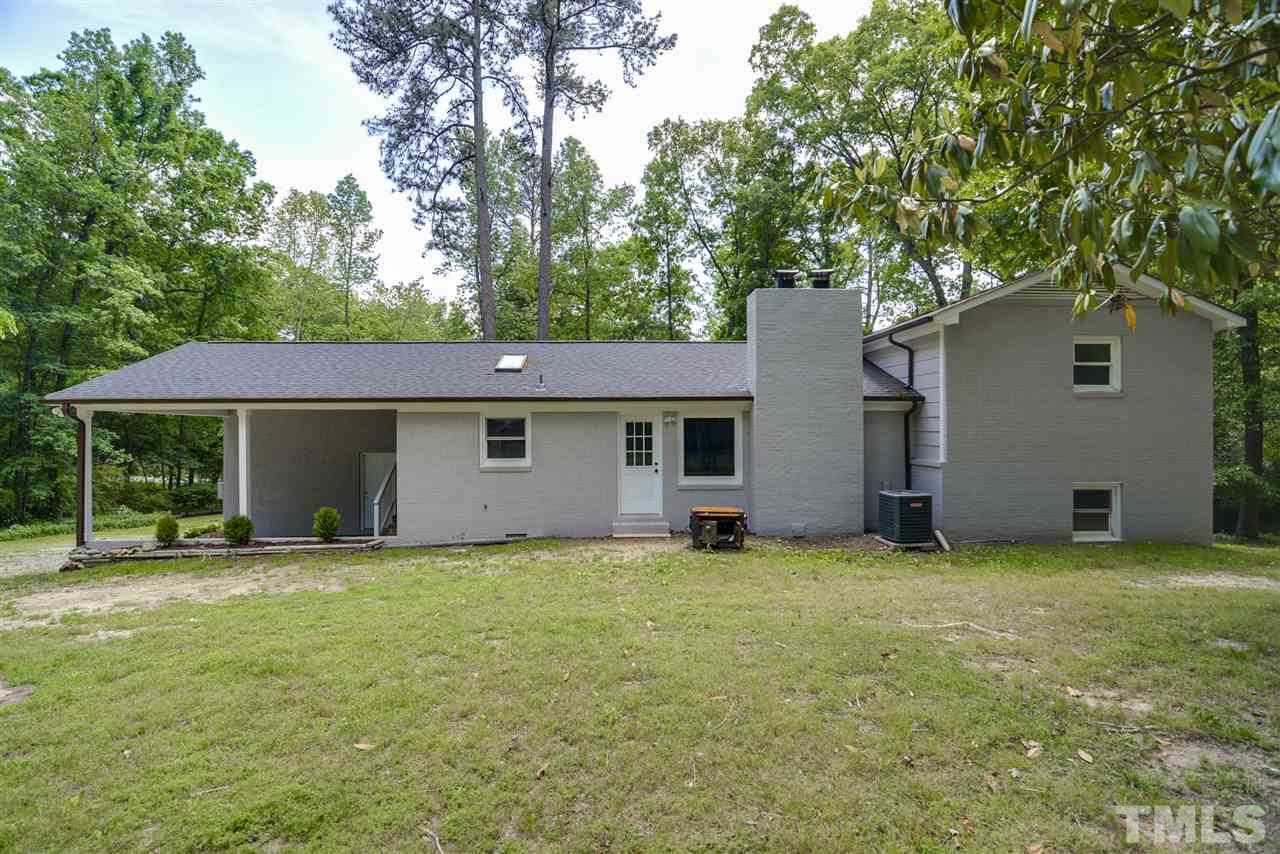 131 Lin Tilley Road Durham, NC 27712 - Photo 5 of 25 a view of a house with a yard and garage