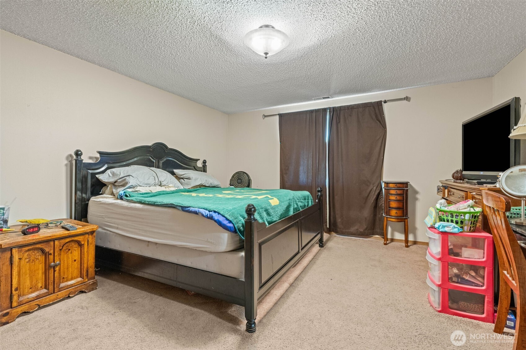 1420 Dundee Drive Cosmopolis, WA 98537 - Photo 28 of 40 a bedroom with a bed and flat screen tv