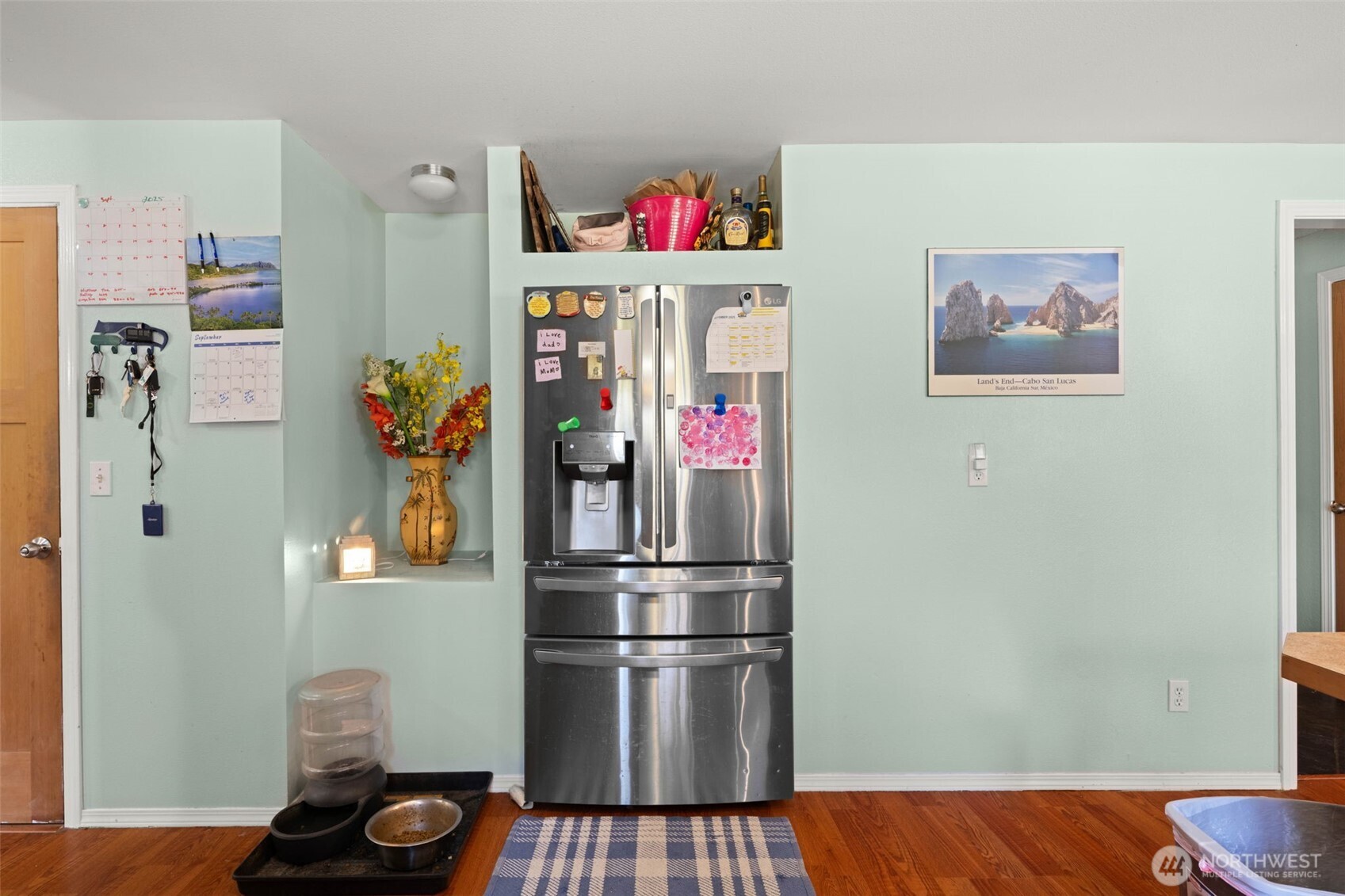 1420 Dundee Drive Cosmopolis, WA 98537 - Photo 7 of 40 a kitchen with a refrigerator and wooden floor