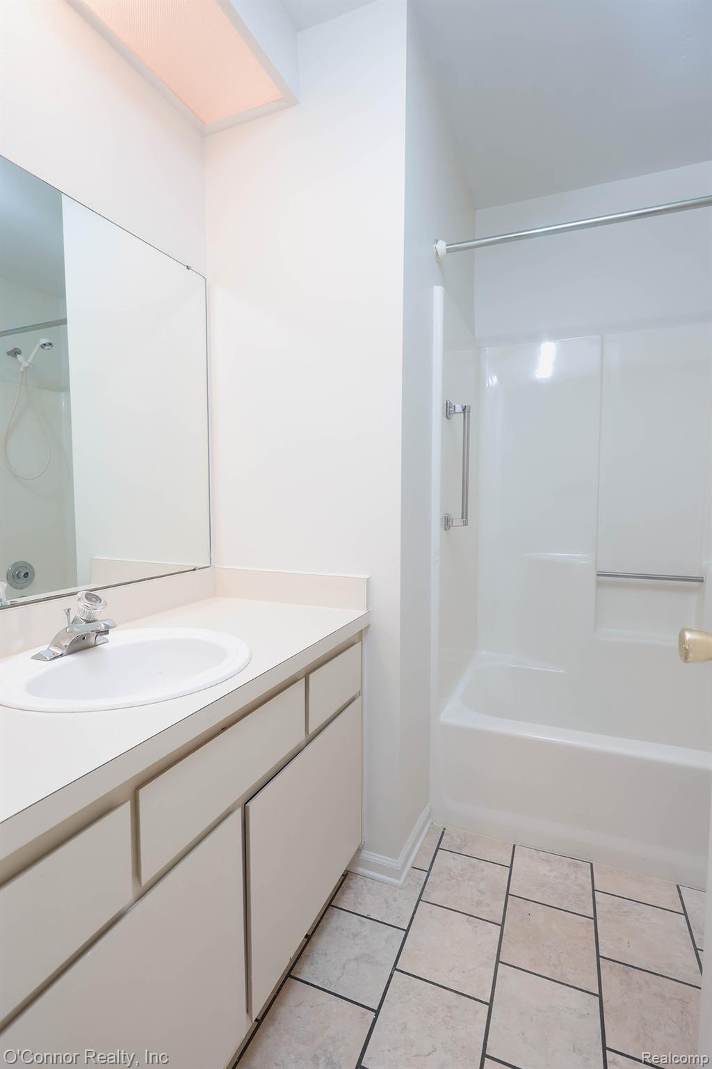 1660 River Road, Unit 53 Marysville, MI 48040 - Photo 23 of 31 Full bathroom featuring vanity, shower / washtub combination, and light tile patterned floors