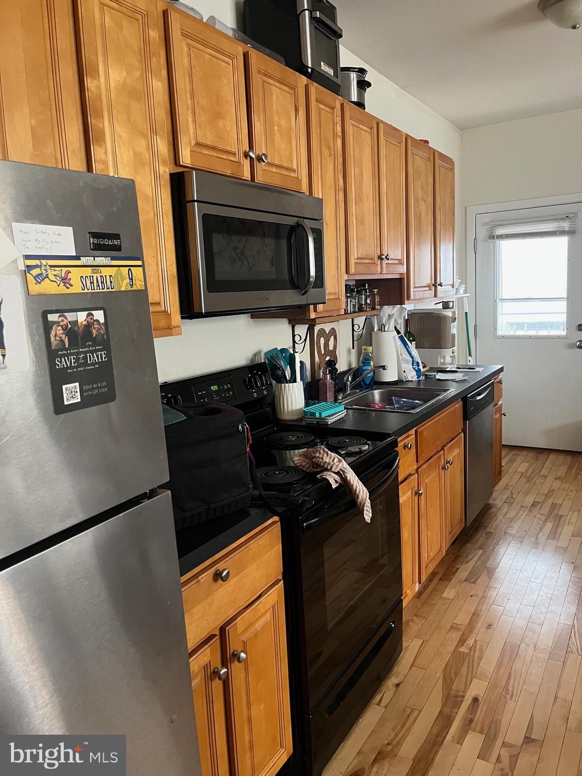 4010 Baring Street Philadelphia, PA 19104 - Photo 13 of 22 a kitchen with stainless steel appliances a stove a microwave a sink and a refrigerator