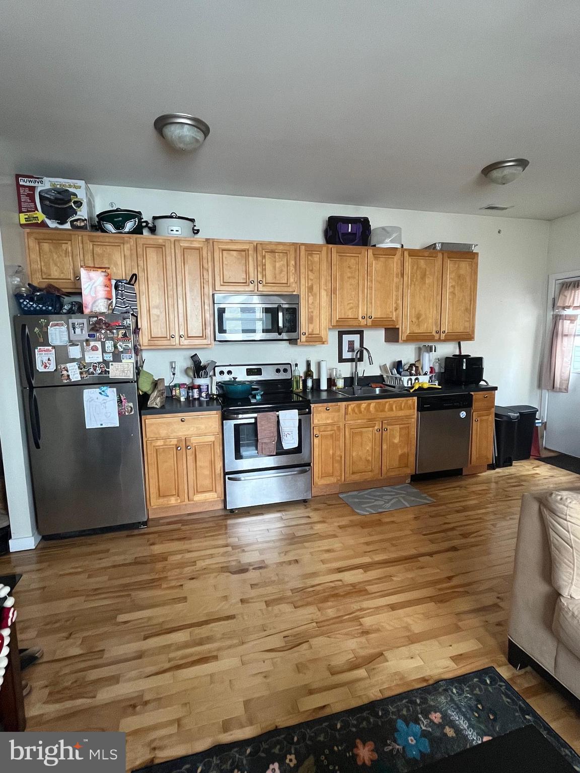 4010 Baring Street Philadelphia, PA 19104 - Photo 14 of 22 a kitchen with stainless steel appliances granite countertop a stove and a sink