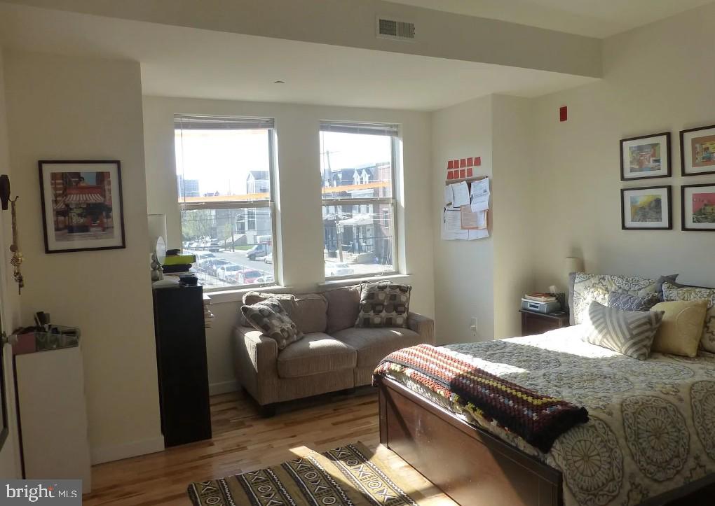 4010 Baring Street Philadelphia, PA 19104 - Photo 18 of 22 a bedroom with a bed and wooden floor