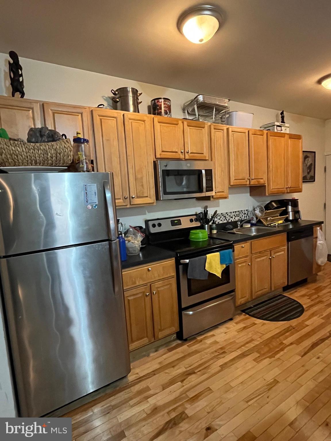 4010 Baring Street Philadelphia, PA 19104 - Photo 21 of 22 a kitchen with stainless steel appliances a stove a refrigerator and a sink