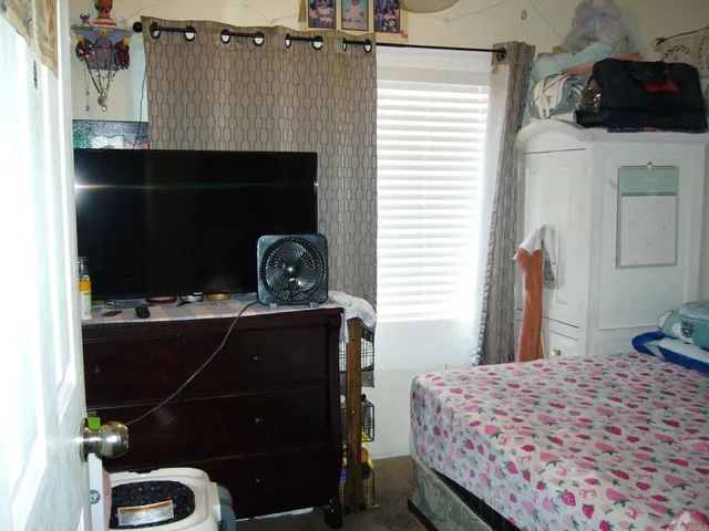 a bedroom with a bed and a dresser