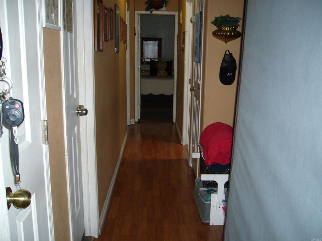 9902 Jamacha Boulevard, Unit SPACE #165 Spring Valley, CA 91977 - Photo 14 of 25 a view of a hallway with wooden floor and a utility room