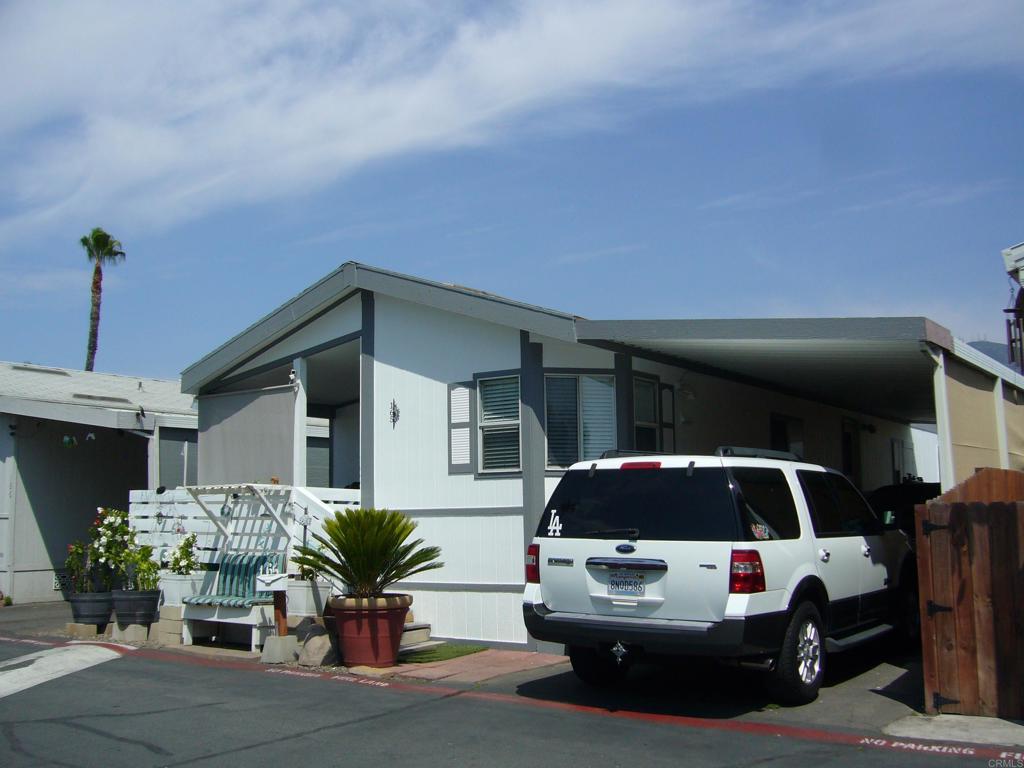 9902 Jamacha Boulevard, Unit SPACE #165 Spring Valley, CA 91977 - Photo 20 of 25 a car parked in front of a house