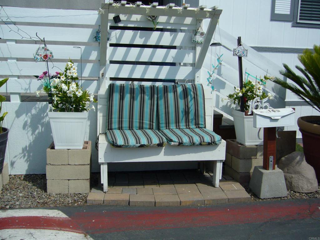 9902 Jamacha Boulevard, Unit SPACE #165 Spring Valley, CA 91977 - Photo 2 of 25 a balcony with furniture and flowers