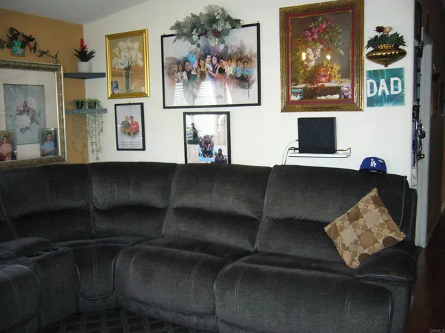 a living room with furniture and painting on the wall