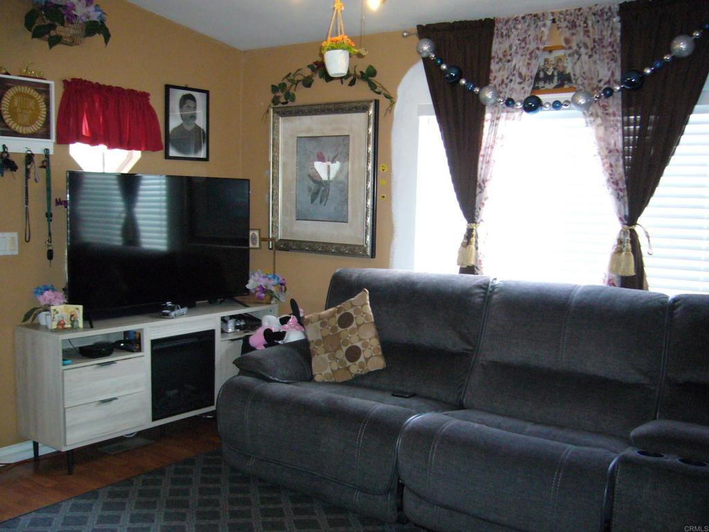 9902 Jamacha Boulevard, Unit SPACE #165 Spring Valley, CA 91977 - Photo 5 of 25 a living room with furniture and a flat screen tv