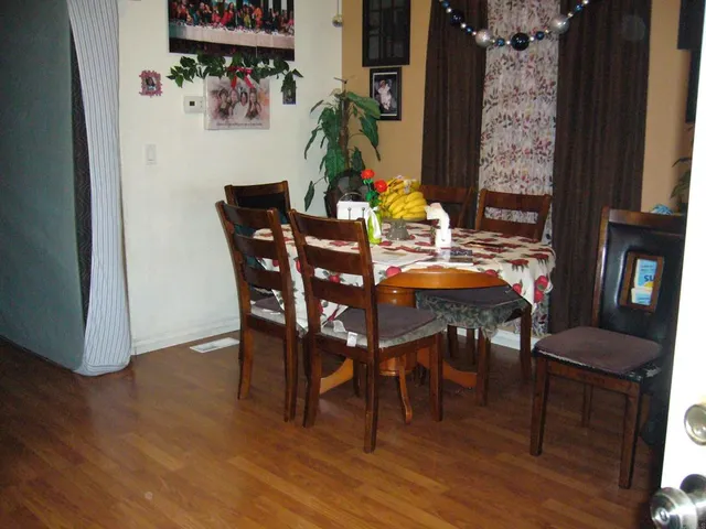 a dining room with furniture and wooden floor