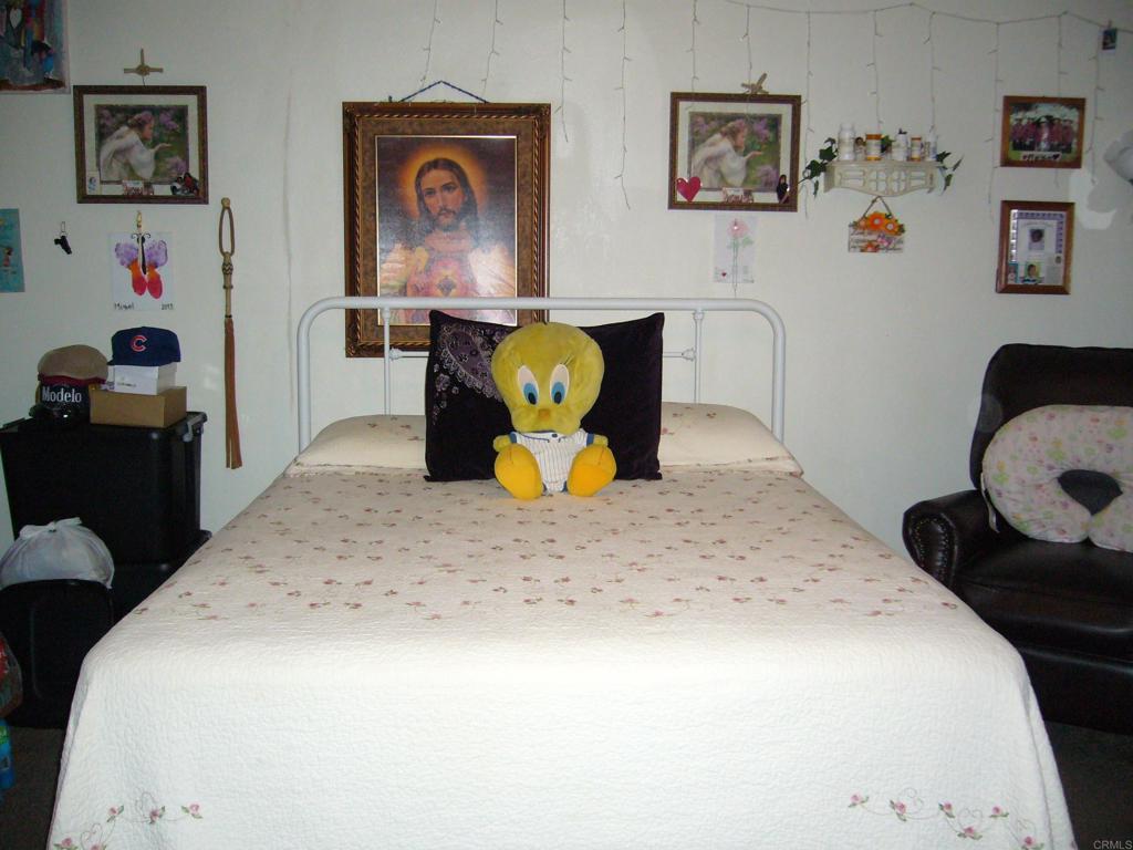 9902 Jamacha Boulevard, Unit SPACE #165 Spring Valley, CA 91977 - Photo 8 of 25 a bedroom with a bed and wooden floor