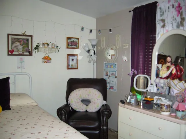 a living room with furniture and wall paintings