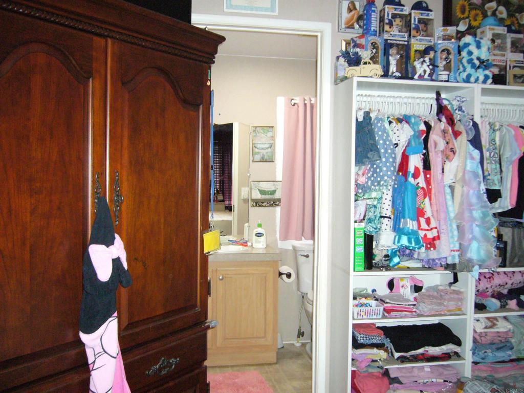 9902 Jamacha Boulevard, Unit SPACE #165 Spring Valley, CA 91977 - Photo 10 of 25 a view of bathroom with a baby crib and a window