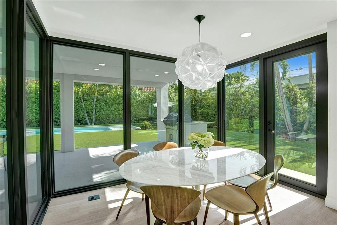 9 Tahoe Lane Sea Ranch Lakes, FL 33308 - Photo 11 of 54 a view of a dining room with furniture large windows and outside view