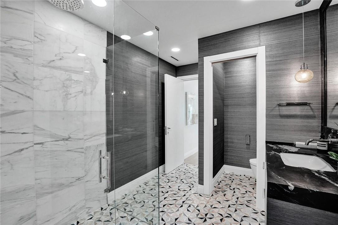 9 Tahoe Lane Sea Ranch Lakes, FL 33308 - Photo 15 of 54 a bathroom with a shower and a sink