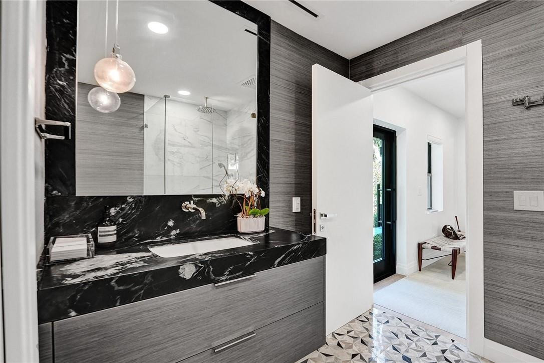9 Tahoe Lane Sea Ranch Lakes, FL 33308 - Photo 16 of 54 a bathroom with a sink and a mirror