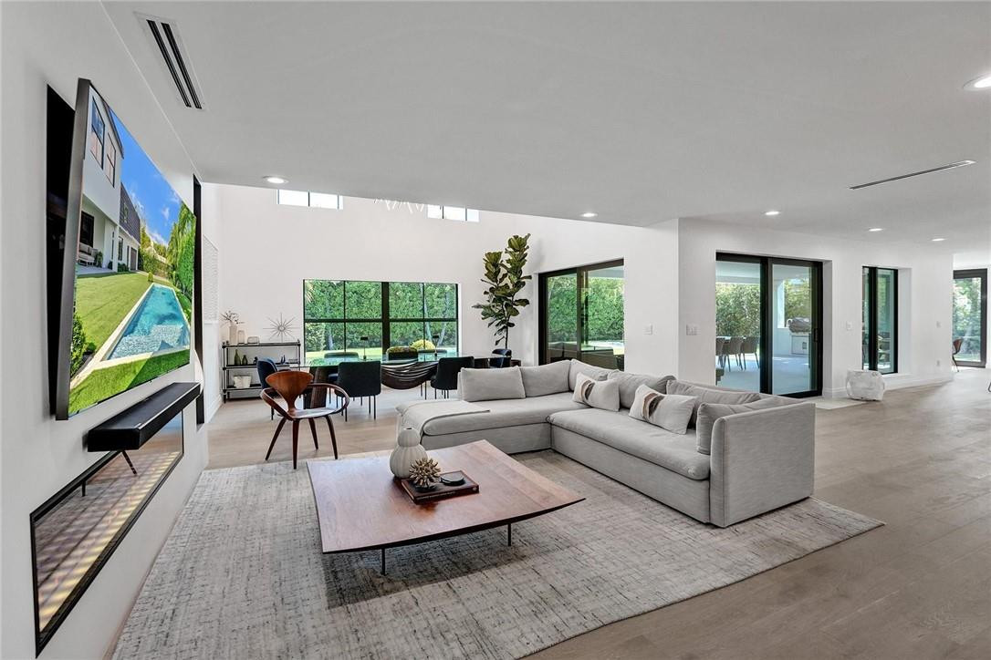 9 Tahoe Lane Sea Ranch Lakes, FL 33308 - Photo 18 of 54 a living room with furniture flat screen tv and a large window