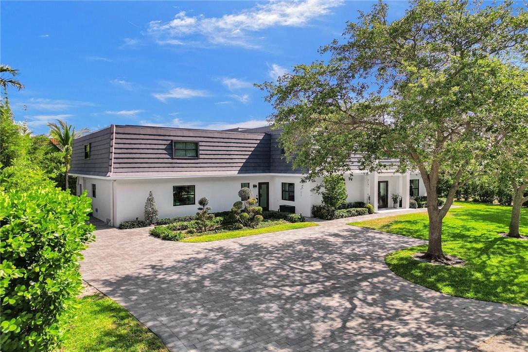 9 Tahoe Lane Sea Ranch Lakes, FL 33308 - Photo 2 of 54 a front view of house with yard and green space