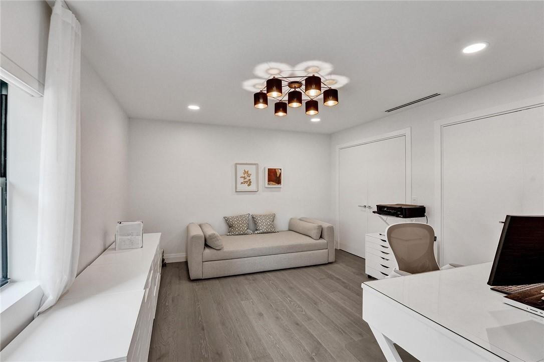 9 Tahoe Lane Sea Ranch Lakes, FL 33308 - Photo 23 of 54 a living room with furniture a couch and chandelier