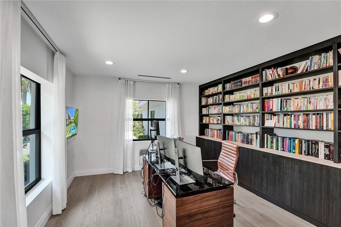 9 Tahoe Lane Sea Ranch Lakes, FL 33308 - Photo 24 of 54 a view of a workspace with furniture and a bookshelf