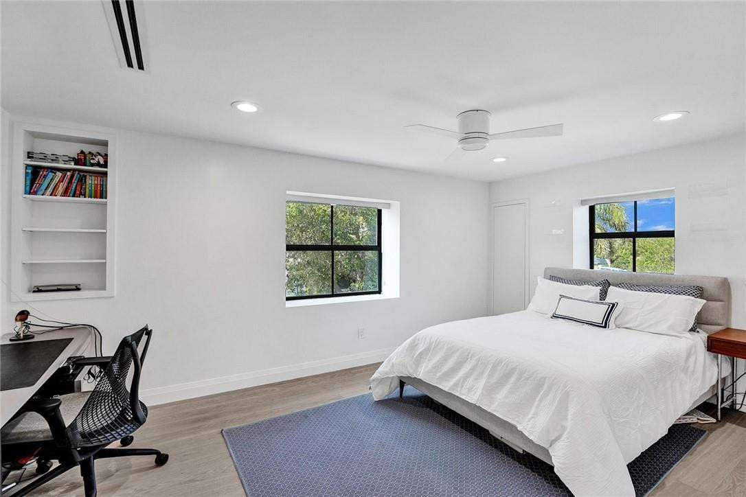 9 Tahoe Lane Sea Ranch Lakes, FL 33308 - Photo 25 of 54 a bedroom with a bed a chair and a window