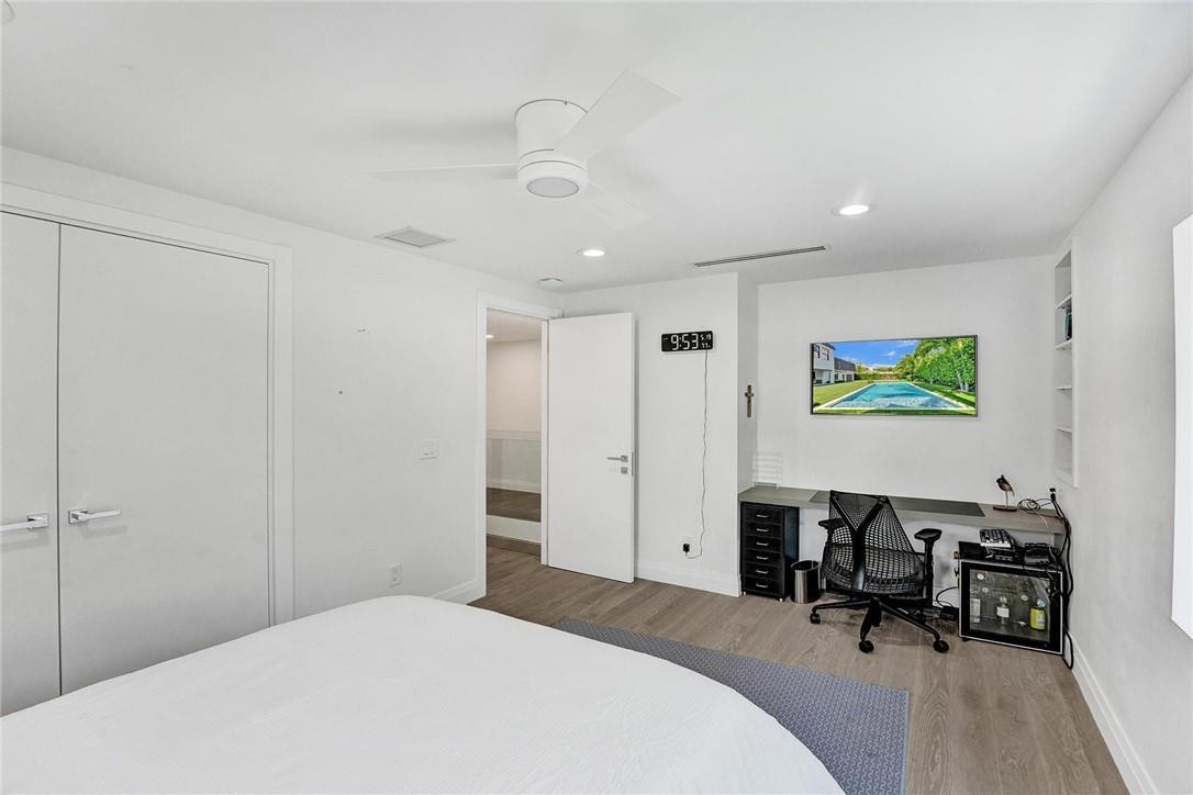 9 Tahoe Lane Sea Ranch Lakes, FL 33308 - Photo 26 of 54 a bedroom with a bed and a table in it