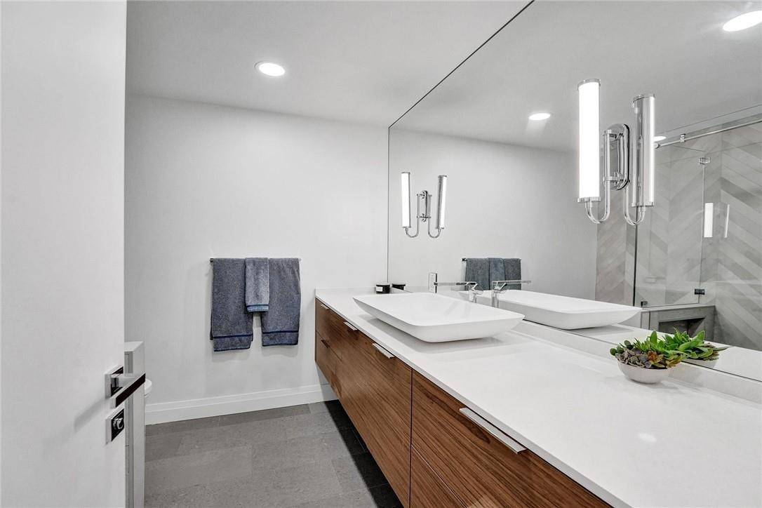 9 Tahoe Lane Sea Ranch Lakes, FL 33308 - Photo 27 of 54 a bathroom with a double vanity sink and a mirror