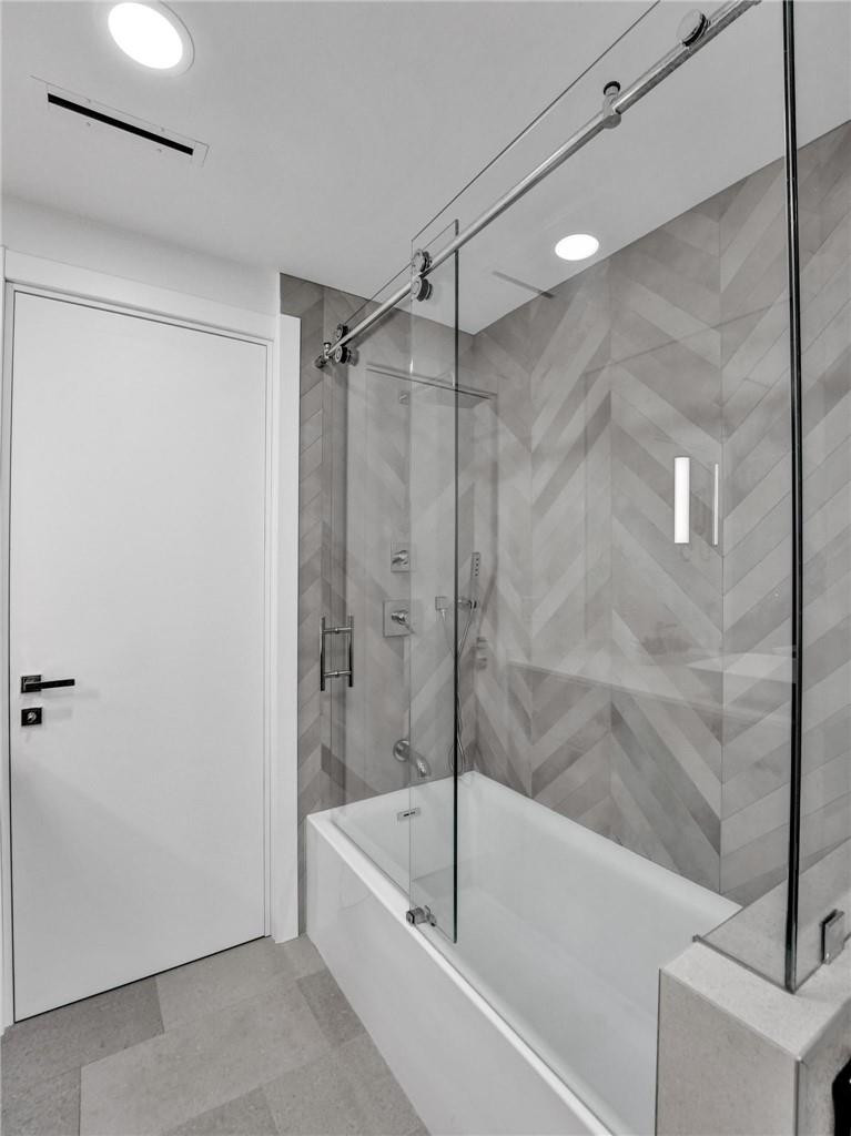 9 Tahoe Lane Sea Ranch Lakes, FL 33308 - Photo 28 of 54 a bathroom with a bathtub and a shower