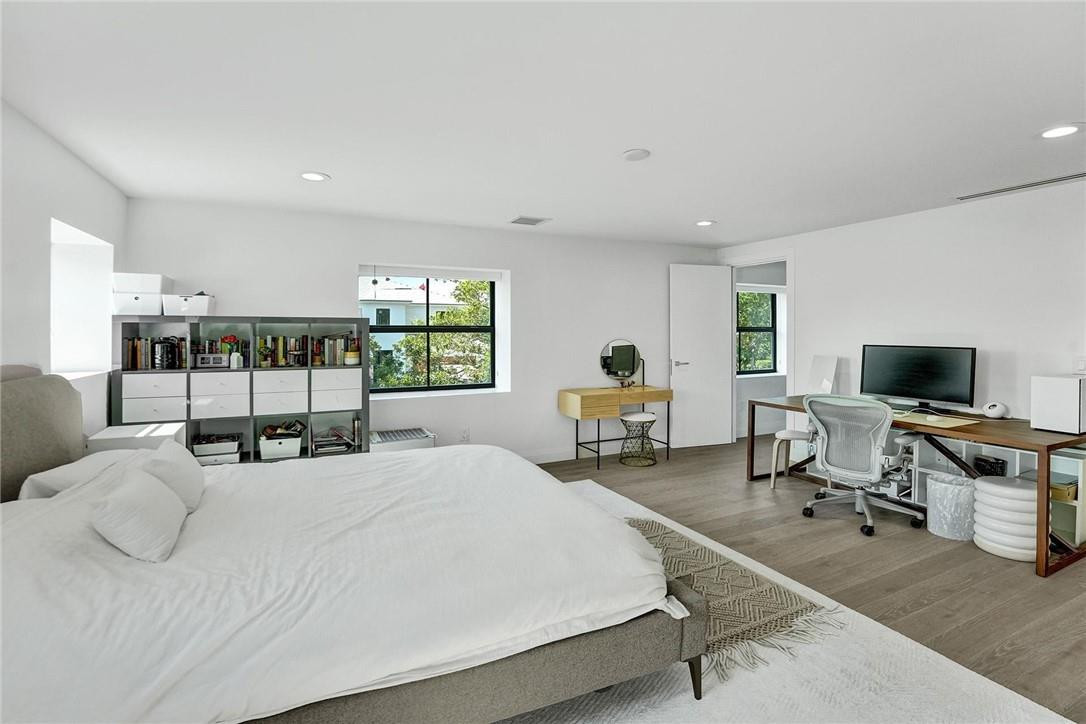 9 Tahoe Lane Sea Ranch Lakes, FL 33308 - Photo 30 of 54 a bedroom with a bed a large window and chair