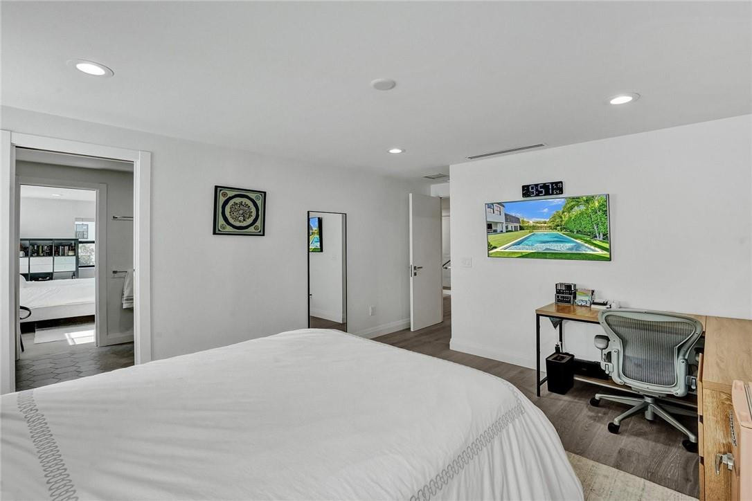 9 Tahoe Lane Sea Ranch Lakes, FL 33308 - Photo 31 of 54 a bedroom with a bed and a desk in it