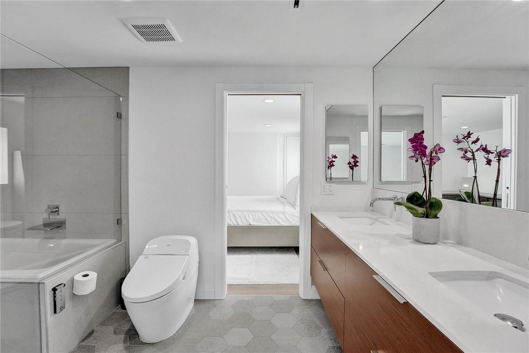 9 Tahoe Lane Sea Ranch Lakes, FL 33308 - Photo 32 of 54 a bathroom with a granite countertop sink mirror and toilet