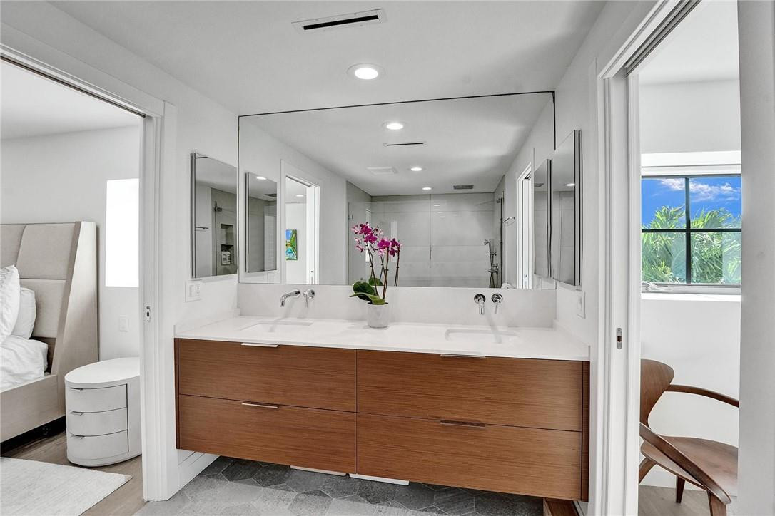 9 Tahoe Lane Sea Ranch Lakes, FL 33308 - Photo 34 of 54 a bathroom with a double vanity sink mirror and toilet