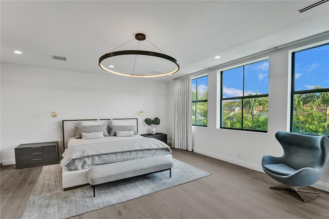 9 Tahoe Lane Sea Ranch Lakes, FL 33308 - Photo 37 of 54 a bedroom with a bed and window