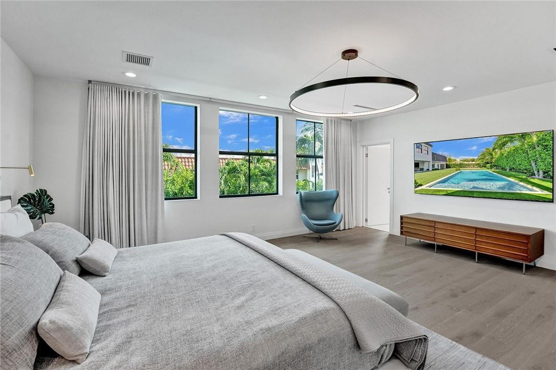 9 Tahoe Lane Sea Ranch Lakes, FL 33308 - Photo 38 of 54 a bedroom with a bed and a large window