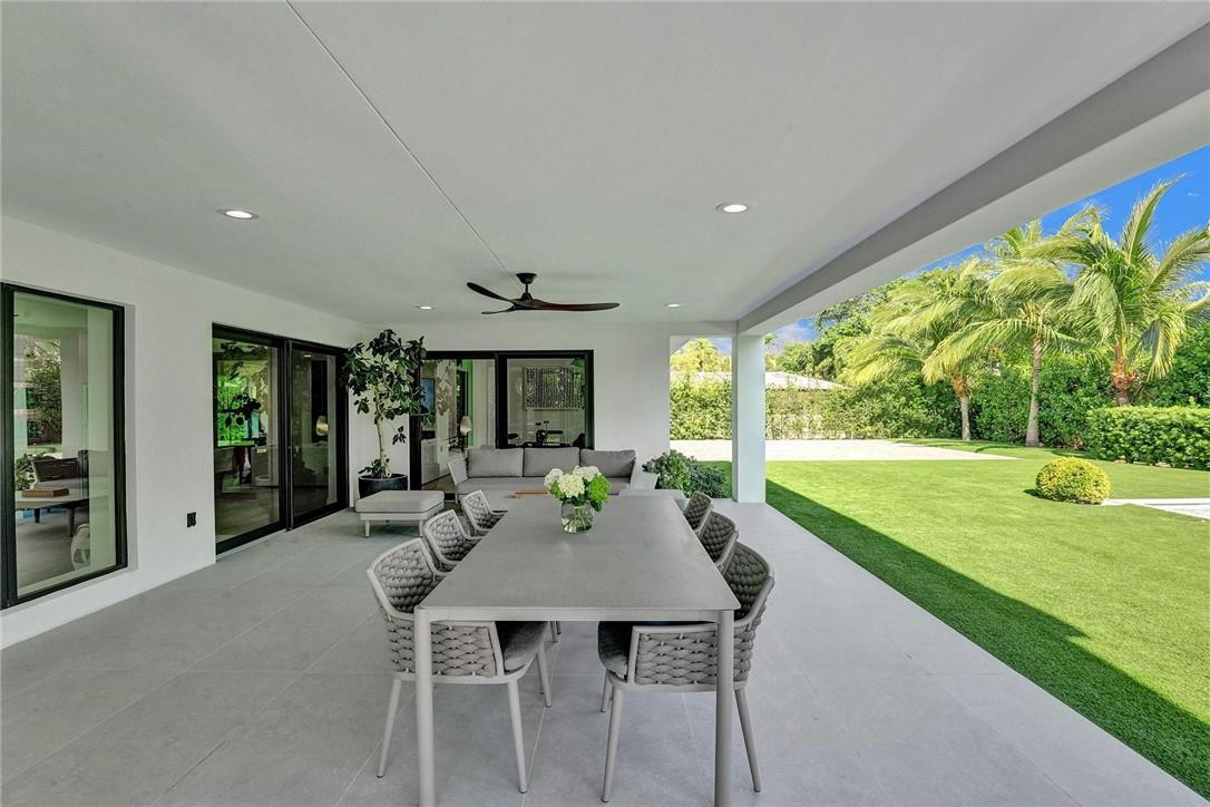 9 Tahoe Lane Sea Ranch Lakes, FL 33308 - Photo 46 of 54 a view of a patio with a table and chairs